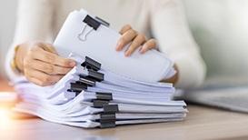 woman going through paperwork on desk